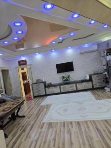 a large room with a flat screen tv on a wall at Hamroz apartment in Navoi