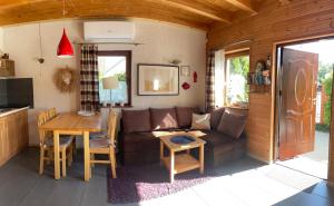 a living room with a couch and a table at Domki Gościniec Bobolin in Bobolin