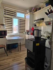 a kitchen with a counter and a table in it at Hamroz apartment in Navoi