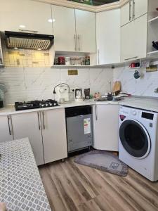 a kitchen with a washing machine and a washer at Hamroz apartment in Navoi