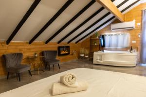a room with a bed and a tub and a fireplace at אחוזת שרון in Elifelet +54 photos