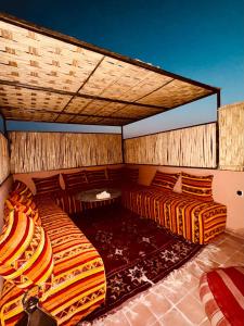 a room with two beds and a table at Riad Kimee in Marrakesh +99 photos