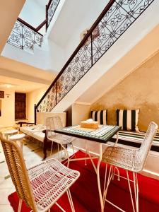 a dining room with a table and chairs at Riad Kimee in Marrakesh