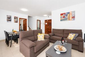 a living room with a couch and a table at Villa Alexsandra in Playa Blanca