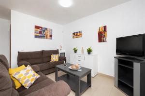 a living room with a couch and a flat screen tv at Villa Alexsandra in Playa Blanca