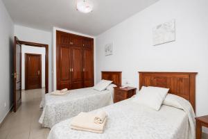 a bedroom with two beds with towels on them at Villa Alexsandra in Playa Blanca +12 photos