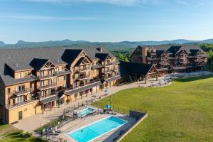 an aerial view of a large house with a swimming pool at Burke Mountain Hotel in East Burke