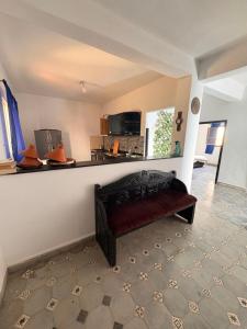 a living room with a red bench in a room at Jara Cimrman surf house in Imsouane +27 photos