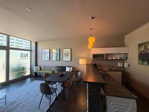 a kitchen and living room with a table and chairs at N8 Rooms by BW Living in Leipzig