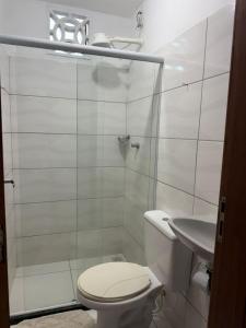 a bathroom with a toilet and a shower and a sink at Suites Prime in Marataizes +14 photos