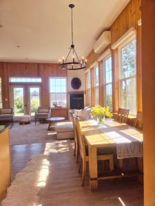 a dining room and living room with a table and chairs at Brackley Beach Schoolhouse in Brackley Beach