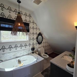 a bathroom with a tub and a toilet at Brackley Beach Schoolhouse in Brackley Beach +4 photos