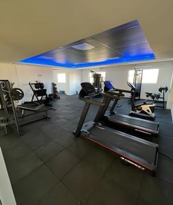 a gym with several treadmills and machines in a room at Studio Moderno Westfit - Barreto in Mossoró