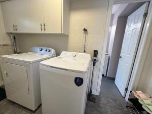 a white washer and dryer in a small room at Amazing Garden view unit in Toronto +17 photos