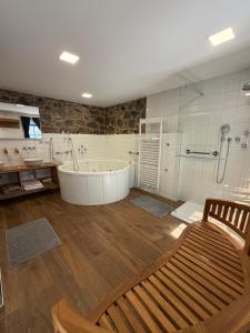 a large bathroom with a tub and a shower at ŠTAJNHAUS DUBICE in Řehlovice