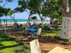 a group of chairs and tables on the beach at Paperon Butik Otel in Erdemli
