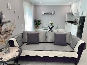 a living room with a couch and a table at Amazing Garden view unit in Toronto