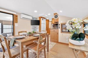 a kitchen and dining room with a table and chairs at Key Largo Tiny House, Marina, Beach, and Pool Access in Key Largo