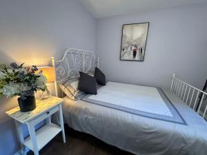 a small bedroom with a bed and a table with a plant at Amazing Garden view unit in Toronto