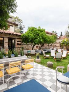a patio with chairs and tables in a yard at House 5 Hotel in Antalya
