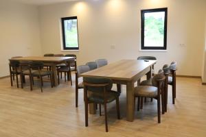 a group of tables and chairs in a room at Lalveri INN in Mestia