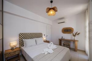 a bedroom with a white bed with a white towel on it at Casa Di Flora in Agios Prokopios