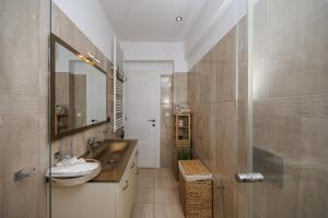 a bathroom with a sink and a mirror at Casa Di Flora in Agios Prokopios +29 photos
