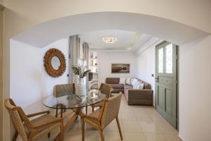 a dining room with a glass table and chairs at Casa Di Flora in Agios Prokopios