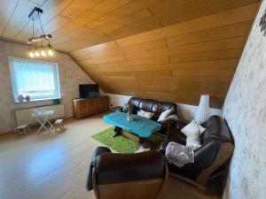 a living room with a couch and a table at Wohnen nahe der Ems in Fresenburg