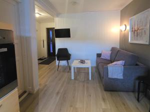 a living room with a couch and a table at Airport Central Apartment in Alta
