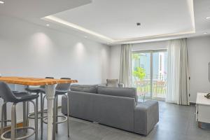 a living room with a couch and a table at Degirmenburnu Residence in Bodrum City