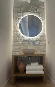a bathroom with a sink and a mirror at Pietra Museum Suites Sirolo in Sirolo