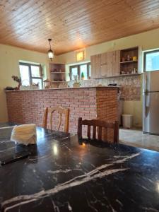 a kitchen with a black counter top and a refrigerator at Villa Borjomi in Akhaldaba