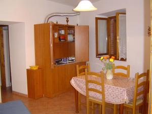 a kitchen with a table and a dining room at Agriturismo Sorripe in Montelaterone