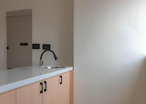 a kitchen with a sink and a mirror at Casa Hotel Hitech City in Hyderabad +29 photos
