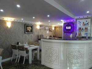 a restaurant with a bar with a table and chairs at Send Apart Otel in Antalya