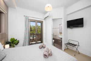 a bedroom with a bed with two towels on it at Villa Vatia 1 in Tragaki +31 photos