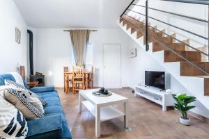 a living room with a blue couch and a table at Casa Susa in Adeje