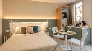 a bedroom with a bed and a table with chairs at Salyn Apartments - The Heart of Tropea - Your Perfect Stay in Tropea