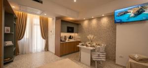 a living room with a tv on a wall at Salyn Apartments - The Heart of Tropea - Your Perfect Stay in Tropea +43 photos