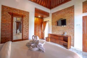 a bedroom with a bed with a statue of a bunny at The Garuda Villa and Restaurant in Bedugul