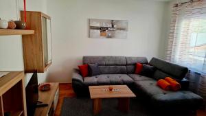 a living room with a couch and a coffee table at Apartma Center in Bovec