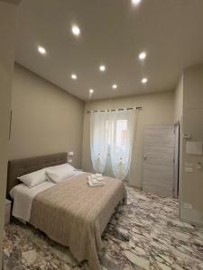 a bedroom with a large bed and a window at Scilla Central Rooms in Scilla