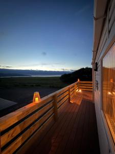 a deck with lights on the side of a house at Beachcomber's Paradise in Castlegregory