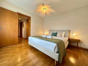 a bedroom with a bed and a ceiling fan at Douro View by Porto in Valbom