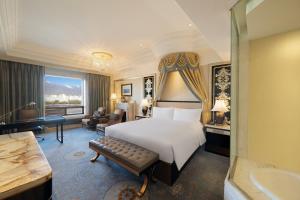a hotel room with a bed and a bathroom at InterContinental Lhasa Paradise by IHG in Lhasa +107 photos