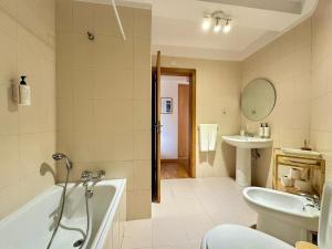 a bathroom with a tub and a sink at Douro View by Porto in Valbom +28 photos