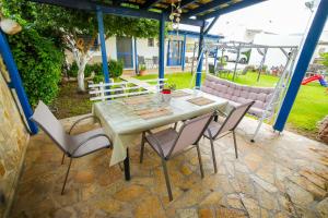 a table and chairs on a patio at Efi Pool & View Alepochori i in Kato Alepochori