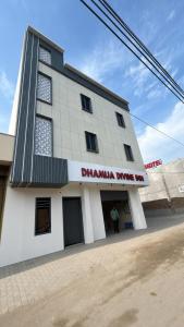a man standing in front of a building at Hotel Dhamija Divine inn Sirsa in Sirsa