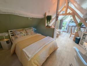 a bedroom with a bed in a room at Quiet Riverside Apartment in Grosley-sur-Risle
